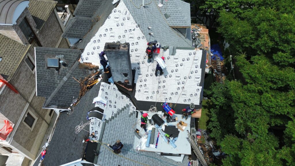 Roof repair and chimney service being provided by Financial District Roofing professionals