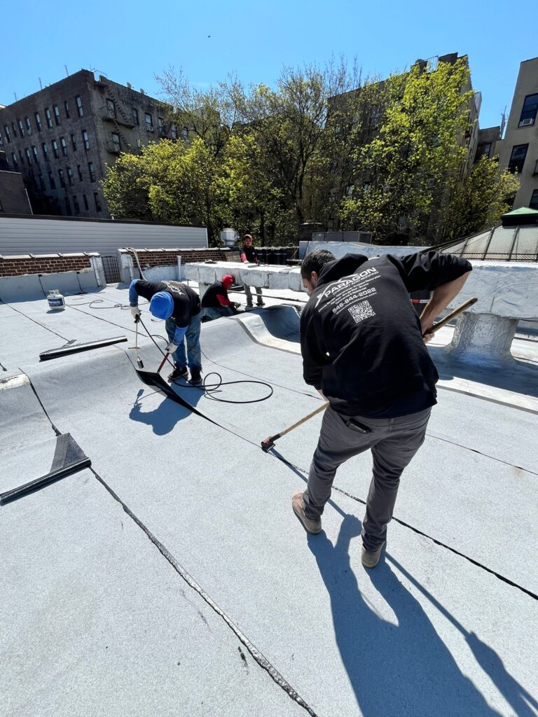 Skilled roofers from Morrisania Roofing working on a residential roof