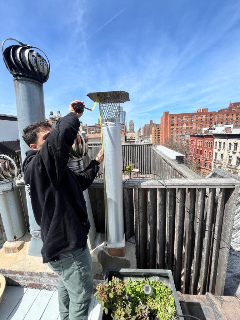 Tompkinsville Roofing team working on chimney repair for a residential property