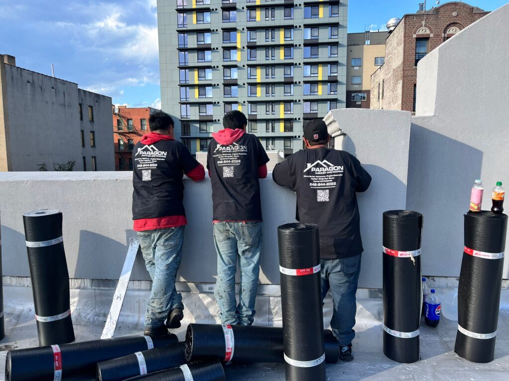 Roofers from Riverdale Roofing planning the next steps on a roofing project